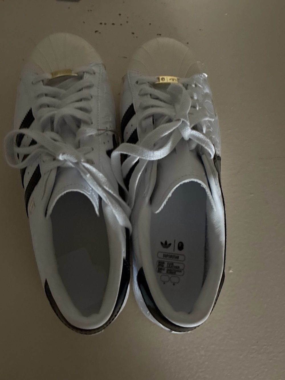 Bape White Sneakers with Black Stripes and Gold Tongue Accents
